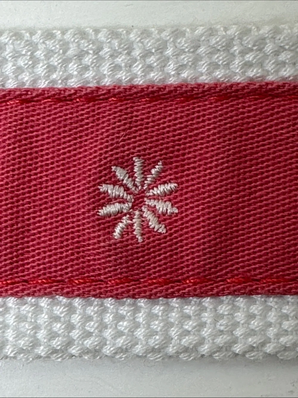 Unbranded coal and white ribboned web belt with silver tone buckle.